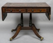 A Regency rosewood sofa table The twin flap rectangular top above twin brass line inlaid frieze