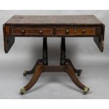 A Regency rosewood sofa table The twin flap rectangular top above twin brass line inlaid frieze