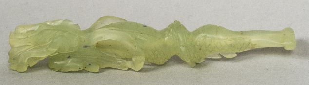 A Chinese carved pale jade cheroot holder Worked as a dragon. 11 cm long.