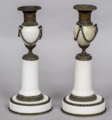 A pair of Grand Tour candlesticks Each urn shaped porcelain body with bronze mounts,