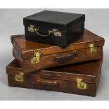 An early 20th century tan leather suitcase, stamped Asprey, London Mounted with brass lock plates,