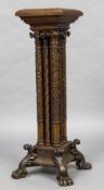 A 19th century walnut pedestal With foliate carved columns, standing on four carved paw feet.