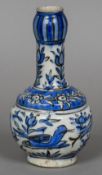 An Iznik style pottery vase With elongated neck above the bulbous body decorated with fish and