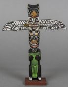 A Canadian carved and painted wooden miniature totem pole Typically decorated,