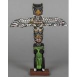 A Canadian carved and painted wooden miniature totem pole Typically decorated,