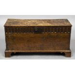 A 17th/18th century oak plank coffer The front panel with short gadrooned decoration,