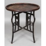 A 19th century Chinese hardwood folding occasional table The circular top with faux bamboo gallery,