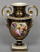 An early 19th century Crown Derby porcelain twin handled urn Painted with a floral vignette within