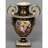 An early 19th century Crown Derby porcelain twin handled urn Painted with a floral vignette within