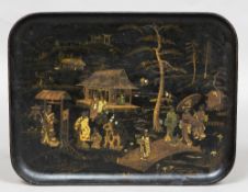 A 19th century papier mache tray With japanned decoration. 61.5 cm wide.