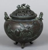 A Japanese bronze censor The pierced cover worked with floral sprays, the body cast with cranes,