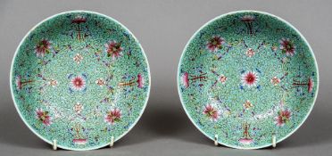 A pair of Chinese porcelain bowls Each decorated with floral scrollwork on a turquoise ground,