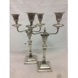 A pair of Victorian silver twin branch candelabra, the bases hallmarked Sheffield 1888,