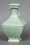 A Chinese porcelain twin handled baluster vase Of square section, worked with archaistic motifs,