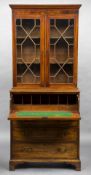 A George III mahogany secretaire bookcase The moulded top above astragal glazed doors enclosing