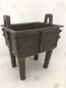 A Chinese bronze Ding twin handled censor With cast archaic decoration. 17 cm wide.