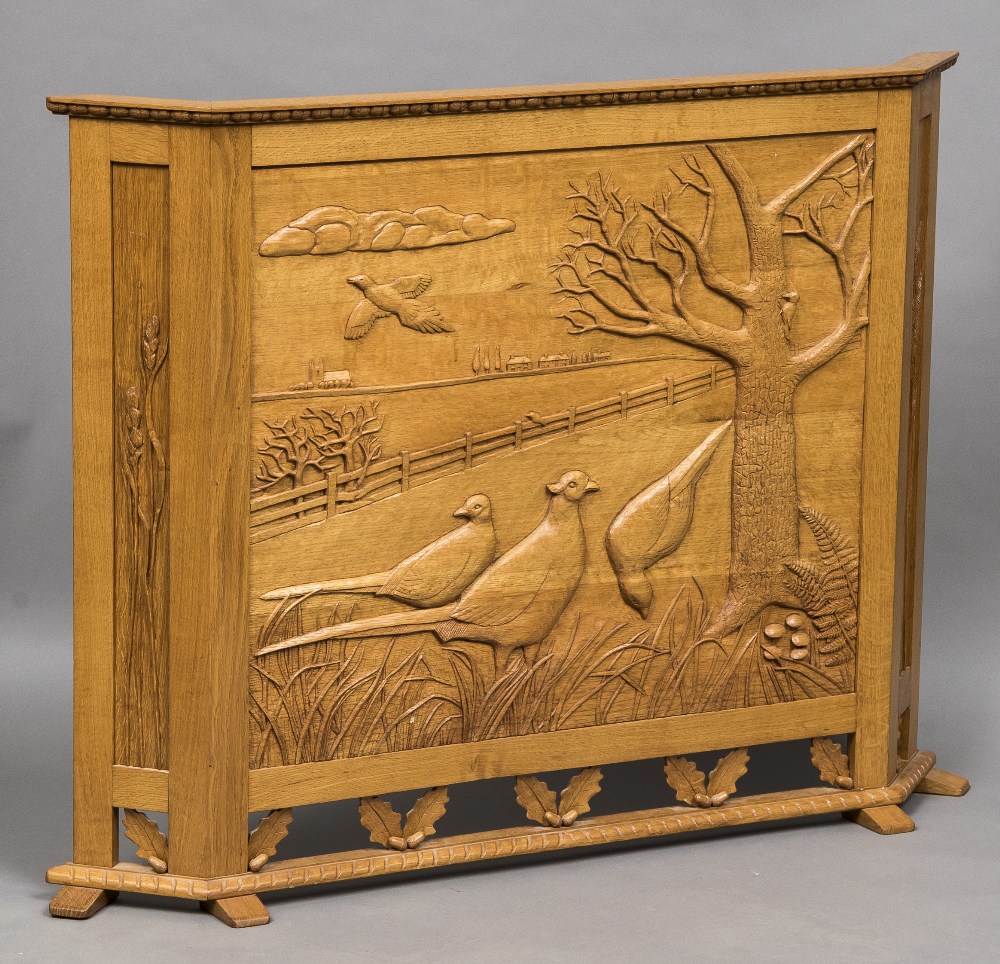 A quarter sawn light oak fire screen Carved with pheasants in a field,