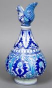 An Iznik style pottery baluster vase Typically decorated, the spout formed as opposing animal masks.