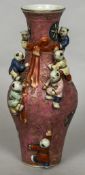 A Chinese porcelain baluster vase Decorated with applied children,