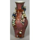 A Chinese porcelain baluster vase Decorated with applied children,