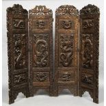 An Eastern carved wood four fold screen Each panel worked in deep relief with mythical beasts