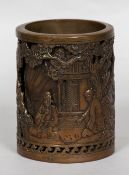 A Chinese cast bronze brush pot Worked with figures playing Go before a pagoda and further figures