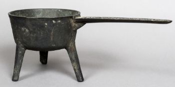 A bronze skillet pan Of typical form, on three angular strut legs, the handle inscribed T.P.