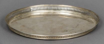 A Dutch silver tray Of oval form with pierced galleried border centrally engraved with a bird