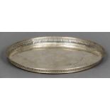 A Dutch silver tray Of oval form with pierced galleried border centrally engraved with a bird