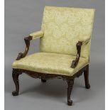 A 19th century mahogany framed Gainsborough armchair The overstuffed back issuing padded acanthus