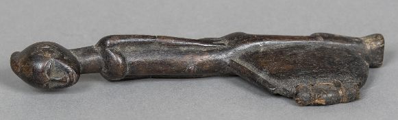 A small African carved wooden tribal hand club The handle formed as a male figure,
