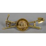 A 14 ct gold diamond set gold mining brooch Modelled as gold pan centred with a log cabin before