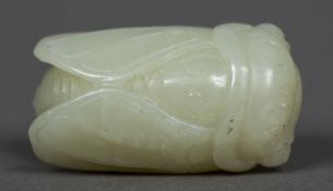 A Chinese carved celadon jade cicada Typically worked. 4.5 cm long.