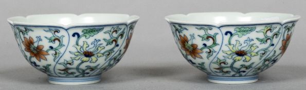 A pair of Chinese Wucai porcelain tea bowls Each with scalloped rim and decorated with lotus