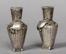 A pair of late 19th/early 20th century Japanese silver pepperettes Each formed as a creel,