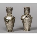 A pair of late 19th/early 20th century Japanese silver pepperettes Each formed as a creel,