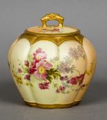 A Royal Worcester blush ivory lidded vase Of lobed form with floral decoration. 17 cm high.