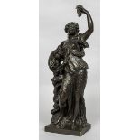 A 19th century patinated bronze figure of a scantily clad maiden Modelled standing before a tree