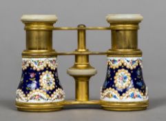 A pair of 19th century French seed pearl and enamel mounted opera glasses Decorated with floral