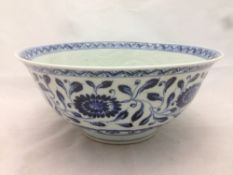 A Chinese blue and white porcelain bowl With incised dragon decoration and decorated with lotus