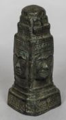 An antique Eastern patinated bronze model of a four sided shrine Each side decorated with a face.