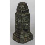 An antique Eastern patinated bronze model of a four sided shrine Each side decorated with a face.