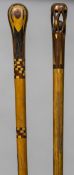 An early 20th century inlaid walking stick The handle pierced enclosing a ball;