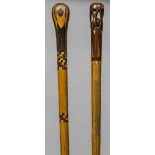 An early 20th century inlaid walking stick The handle pierced enclosing a ball;