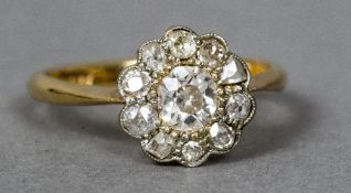 An 18 ct gold and diamond ring Of flowerhead form.