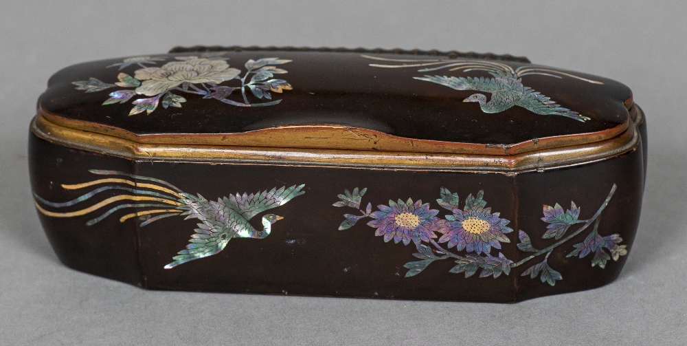 A 19th century mother-of-pearl inlaid lacquered box Of shaped hinged form,