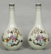 A pair of Chinese porcelain baluster vases Each decorated with figures in a continuous garden