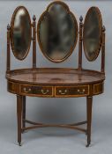 An Edwardian mahogany dressing table Of crossbanded oval form with three bevelled mirrors above two