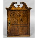 An 18th century walnut and oak spice cupboard The moulded broken swan neck pediment above the