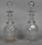 A pair of cut glass decanters and stoppers 31 cm high.